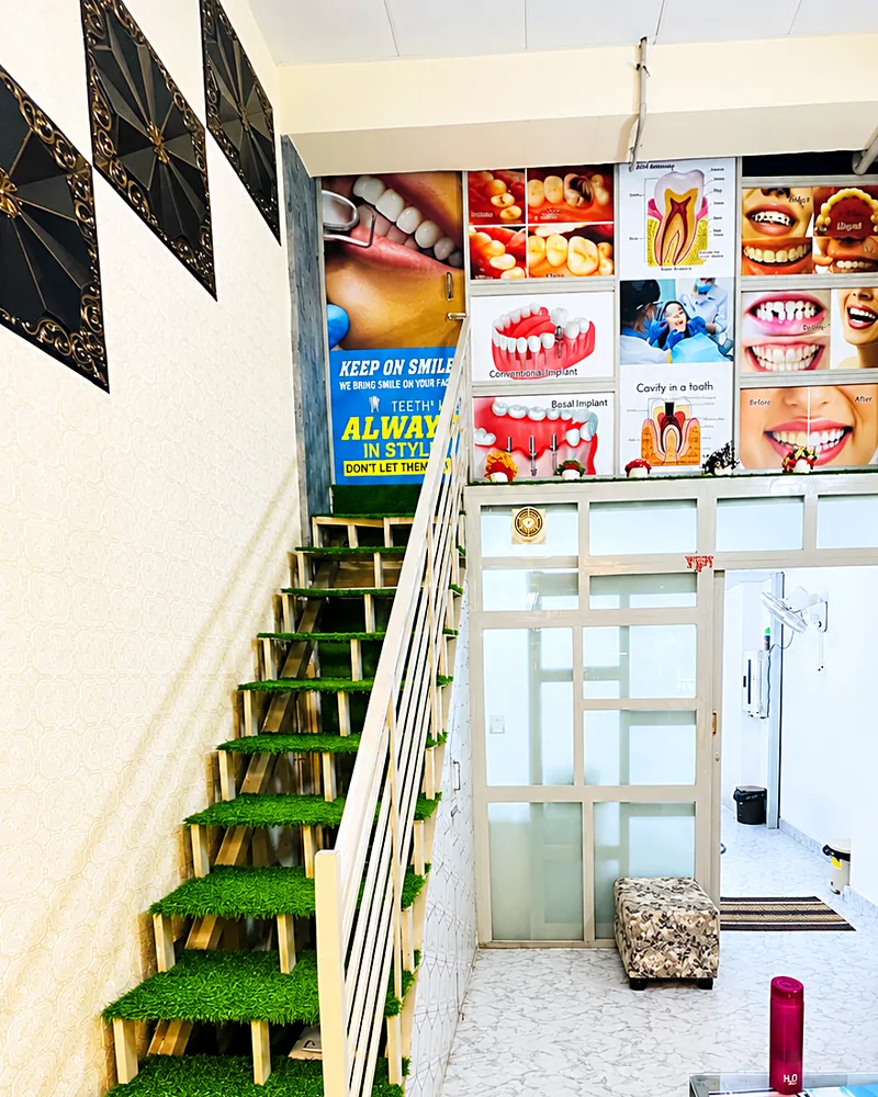 Waiting area with stairs and dental posters
